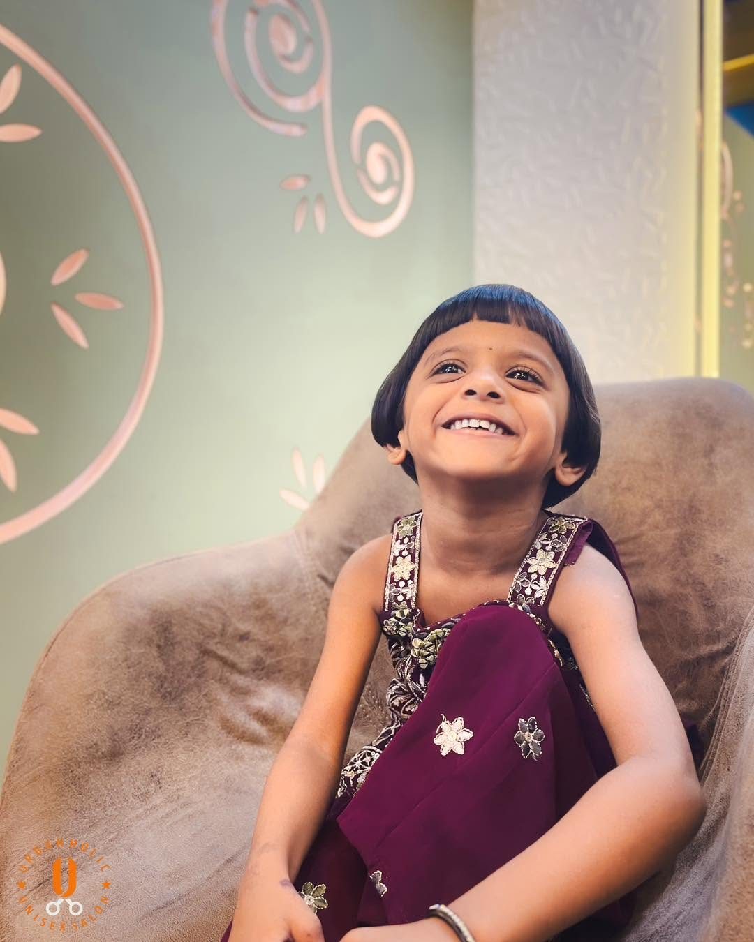 A young guest smiling in the chair